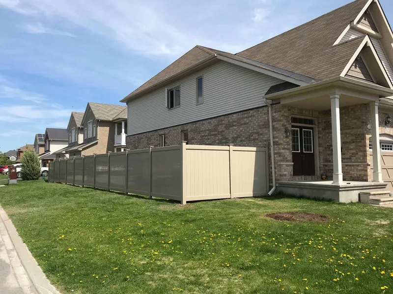 Beige PVC fences installed across several lots in the same neighbourhood