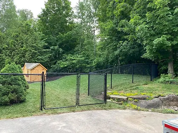 Black chain link fence with a double gate