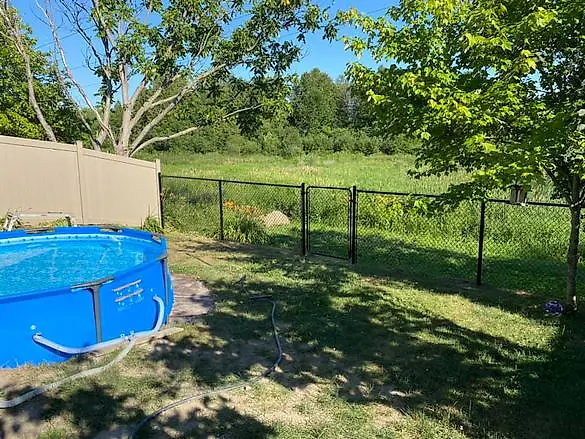 Black mesh fence installed around a pool
